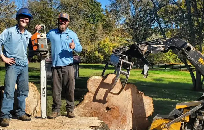Home 48 Owner and employee of TN Tree Preservation holding chainsaw